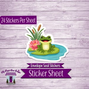 May include: Sticker sheet featuring a cheerful green frog on a lily pad with a pink flower and cattails. The sticker sheet has the text "24 Stickers Per Sheet" and "Envelope Seal Stickers Sticker Sheet". The background is a light purple wood grain.