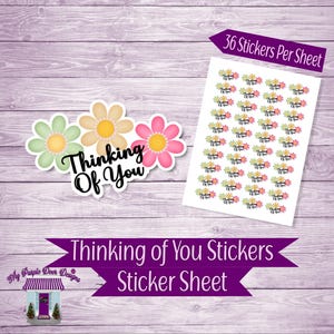 May include: A sheet of 36 stickers featuring three stylized flowers in green, yellow, and pink with the text "Thinking of You" in black. The sticker sheet is on a wooden background.