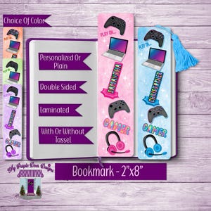 May include: Two personalized gamer bookmarks, one pink and one blue, with a gamer controller, headset, and laptop design. The bookmarks are 2 inches by 8 inches and can be personalized with a name.  "Play On..." and "Gamer" are printed on the bookmarks.