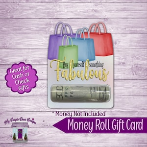 May include: A money roll gift card with a design featuring shopping bags in purple, green, blue, and red. The card has the text "Buy yourself something Fabulous" and a clear window to hold a rolled-up bill. The text "Money Not Included" is also present.