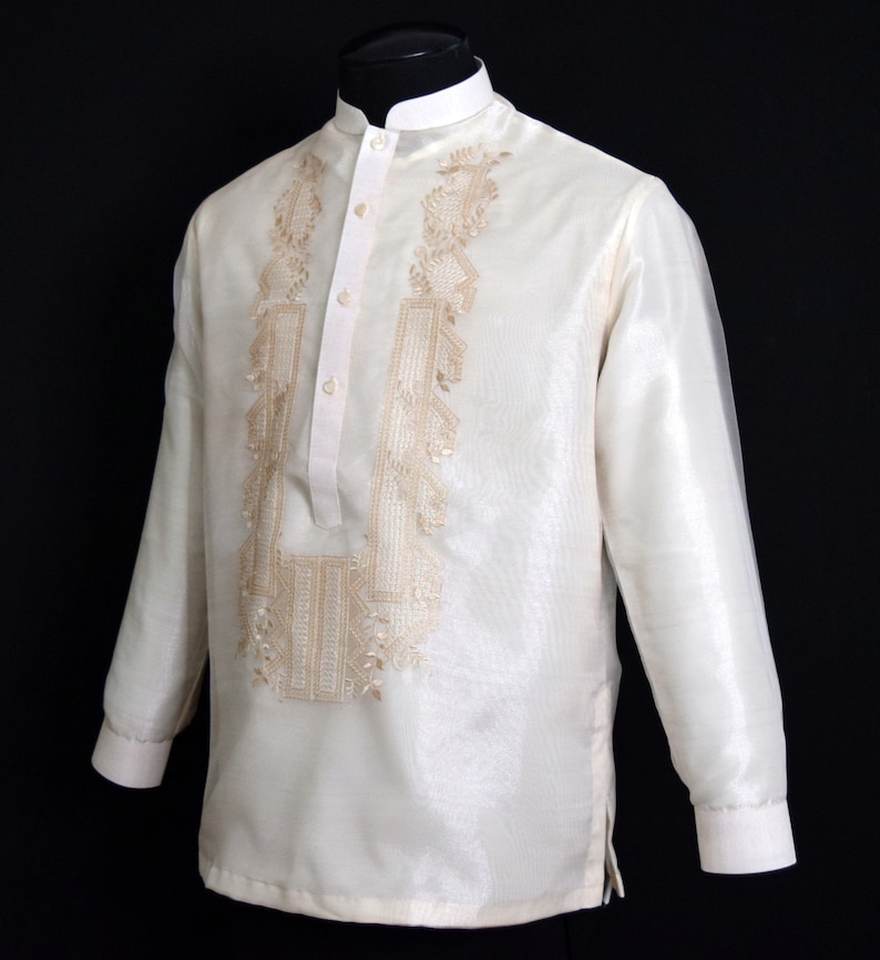Timeless Elegance in Beige: Hand-embroidered on rich Organza fabric, it features a Chinese collar, cuff buttons and comes with an attached lining for added comfort. A symbol of tradition and sophistication for any special occasion.