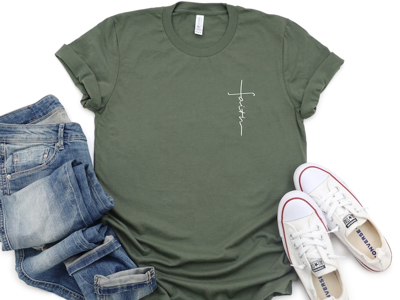 May include: A green t-shirt with a white cross and the word "faith" written vertically on the front.