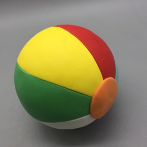 May include: A colorful beach ball with yellow, red, green, white, and orange sections.