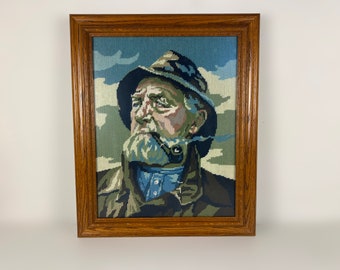 Vintage embroidery wood framed portrait of pipe-smoking fisherman, mid century wall art 1970’s, Original by Harry Haerendel