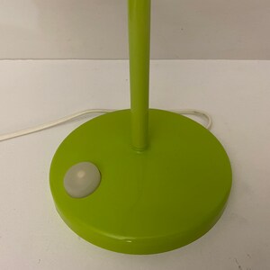 May include: A green table lamp with a white switch on the base.