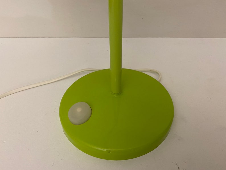 May include: A green table lamp with a white switch on the base.