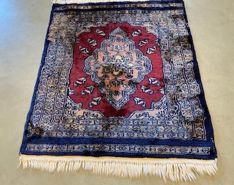 Small colorful oriental rug in red, blue, pink and off white accents, hand made vintage from the 1970's