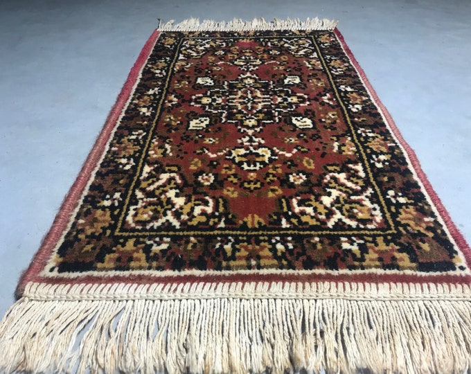 Small oriental rug, table topper, table runner, red, brown, yellow, black and white accents, made of wool, 1960s Mid century modern