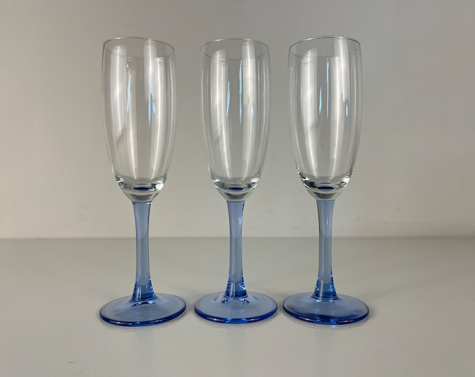 Set of 3 vintage champagne glasses, champagne flutes with a light blue stem. Mid century modern barware 1980s