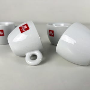 Vintage bar quality porcelain Illy espresso cups, decorated with the classic red Illy logo.