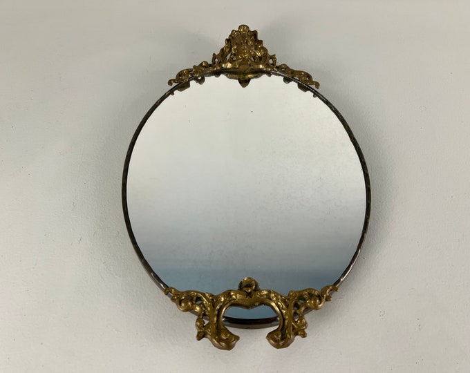 Vintage crested oval wall mirror with brass frame, baroque style with ornaments, lovely mid century modern mirror