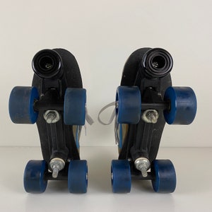 May include: A pair of black roller skates with blue wheels. The skates have a white strap and a black buckle.