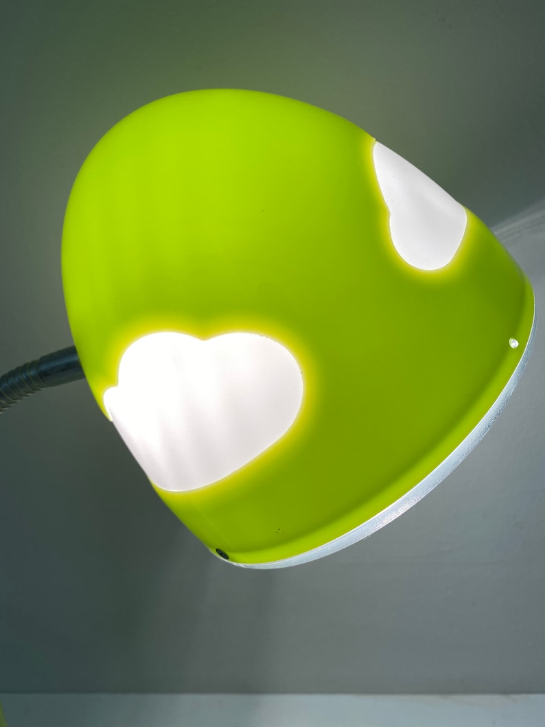 May include: A bright green desk lamp with a white, cloud-shaped cutout on the shade.