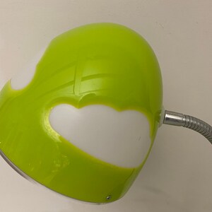 May include: A green desk lamp with a flexible arm and a white, cloud-shaped shade.
