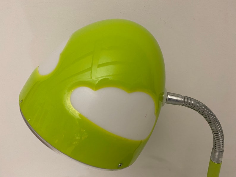 May include: A green desk lamp with a flexible arm and a white, cloud-shaped shade.