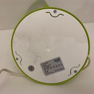 May include: Green and white desk lamp with a white cord and a white base. The lamp has a green shade and a white switch. The base has the text "TYP A0803 Skojig 12V 50-60Hz MAX 20W CE Made in Lithuania" and the IKEA logo with the text "IKEA 19272 1349-3 IKEA of Sweden AB 36-343 01 Almhult".