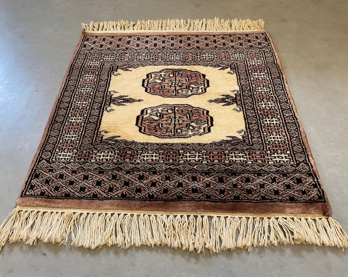 Oriental table rug, small carpet, table topper, table runner, black, off white and pink accents. 1960s style