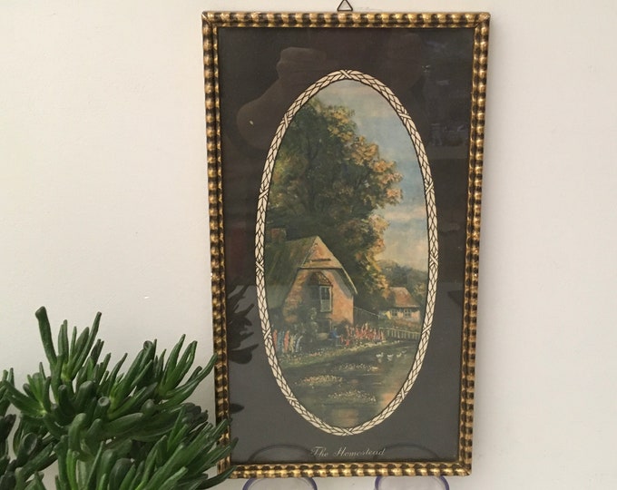 Glass framed print depicting an old English homestead farm, In authentic gold colored mid century frame