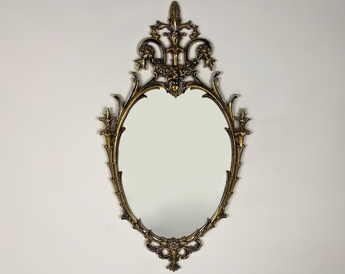 Vintage crested oval wall mirror with brass frame, baroque style with ornaments, lovely mid century modern mirror