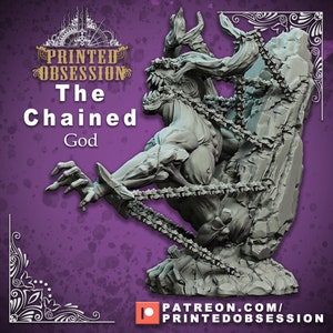 May include: A gray, detailed miniature sculpture of a chained, monstrous creature with a large mouth and horns. The creature is partially embedded in a rock formation. The sculpture is titled "The Chained God" and is from Printed Obsession.