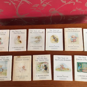 May include: A collection of ten vintage Beatrix Potter children's books featuring illustrations of various characters from the stories. The books are arranged in two rows of five. The books are all in good condition and have a white background with black text and illustrations.