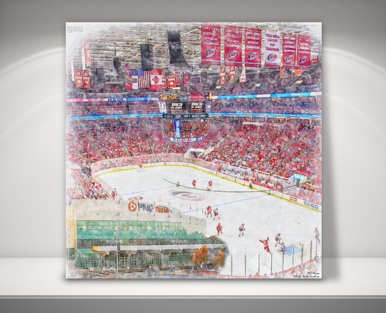 May include: A watercolor painting of a hockey arena with a red and white color scheme. The arena is filled with fans and the ice rink is visible in the center. The words "PNC Arena" are visible on the side of the arena.