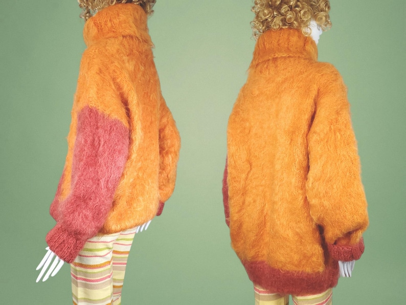 May include: A fuzzy orange and pink sweater with a turtleneck.