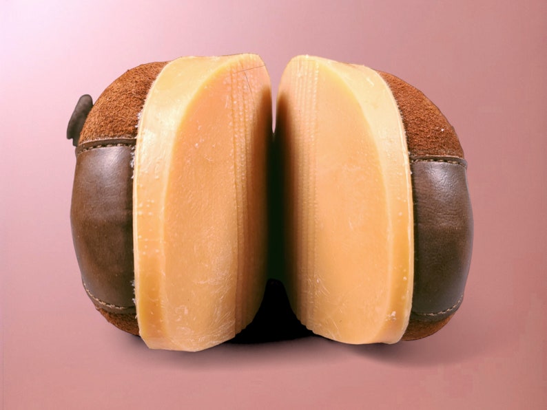 May include: A pair of brown suede shoes with a light brown rubber sole. The shoes are separated to show the sole.