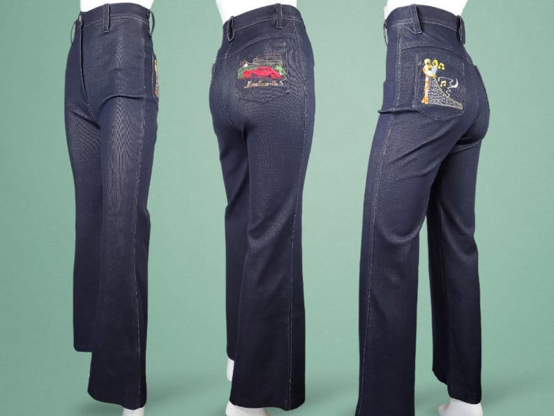 May include: Dark blue denim trousers with embroidered designs on the back pockets. The trousers have a high waist and a flared leg. The embroidery features a red car and a musical note design. A classic vintage style.