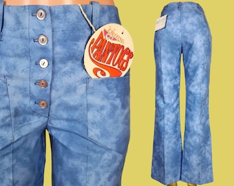 May include: A pair of blue bell bottom pants with a tie-dye pattern. The pants have a button fly and are labeled "Fighting Pantocs".