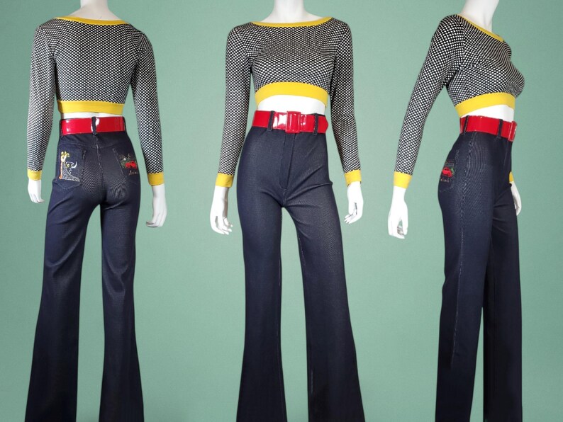 May include: A three-piece outfit comprising a black and white polka dot long-sleeved crop top with yellow trim, a red belt, and dark blue flared jeans. The jeans have embroidered designs on the back pockets. The outfit is displayed on a mannequin.