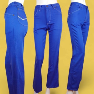 May include: A pair of blue denim jeans with a wide leg and a slight flare at the bottom. The jeans have white stitching and a small red and white detail on the back pocket.