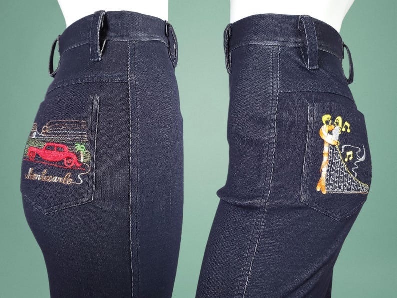 May include: Dark blue denim jeans with embroidered designs on the back pockets. One pocket features a red car and the text "Montecarlo S". The other pocket has an embroidered image of two figures dancing with musical notes.