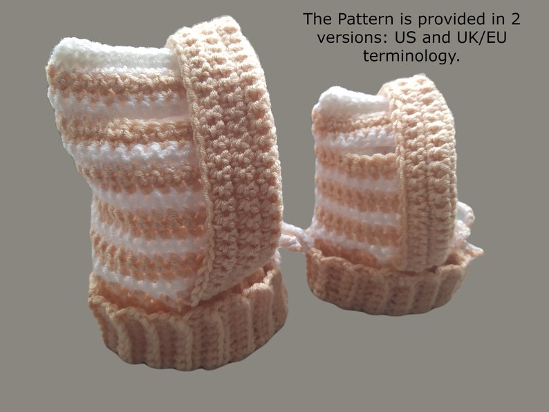 May include: Two crocheted baby booties in a peach and white striped pattern. The booties are made with a soft yarn and have a simple design.