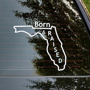 May include: White vinyl decal of the state of Florida with the words "Born & Raised" written vertically inside the outline of the state.