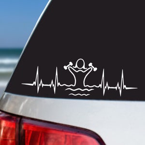 May include: White vinyl decal of a person exercising with dumbbells in water with a heartbeat line. The decal is on a black car window.