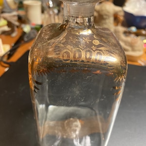Antique blown glass bottle with gold gilding.