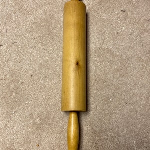 Wood rolling pin with metal rod center