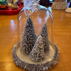 Glass cloche ornament with bottle brush trees