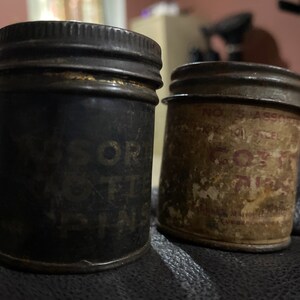 2 old tins full of cotter pins. Both tins are in rough shape. Pins included in both tins.