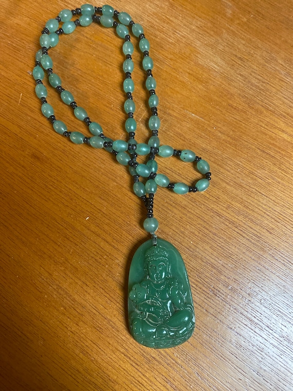 Carved stone likely jade Buddha necklace