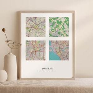 May include: A framed print with four maps of different cities. The text "SARAH & JOE ADVENTURING TOGETHER SINCE 2010" is at the bottom of the print.