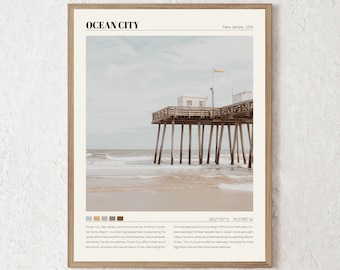 May include: A photograph of a wooden pier extending out over a sandy beach with a small white building on the end. The sky is a light blue with some clouds. The text "OCEAN CITY" is at the top of the image, and the text "New Jersey, USA" is below it. The text "39.2776°N 74.5746°W" is in the bottom right corner of the image.