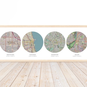 May include: A framed print with four circular maps of different cities. The cities are Santa Ana, Chicago, Coventry, and Salem. Each map is labeled with the city name and coordinates.