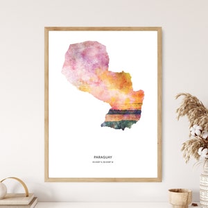 May include: A watercolor painting of the country of Paraguay in shades of pink, orange, and yellow. The painting has a sunset effect with a reflection of the sunset in the water. The text "PARAGUAY 25.4429° S, 58.4439° W" is printed below the painting.
