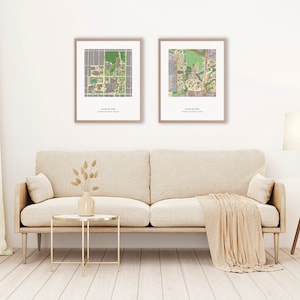 May include: Two framed maps of a university campus, hanging on a white wall above a beige couch with a throw blanket. The maps are labeled "Class of 2023" and "Class of 2024".