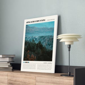 May include: A poster with a photograph of a mountain range with a blue and green color scheme. The poster has the text "Appalachian Mountains" and "Eastern United States" at the top. The poster also includes the coordinates "36.3055&deg; N 81.7028&deg; W".