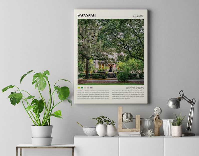 May include: A vintage-style poster with a photograph of a house with a large tree in front of it. The poster has the text "SAVANNAH" in large letters at the top and "Georgia, USA" in smaller letters at the top right. The poster also includes the text "32.0809&deg;N, 81.0906&deg;W" at the bottom.