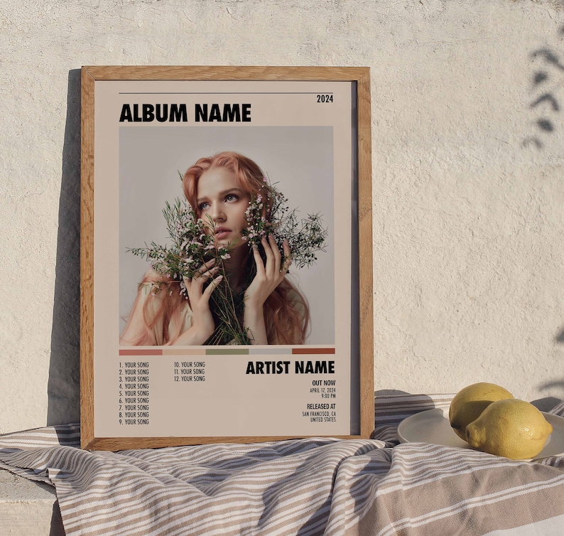 May include: A framed album cover with a woman with long red hair holding a bouquet of white flowers. The album cover is titled "ALBUM NAME" and features the artist name "ARTIST NAME". The album was released in 2024.