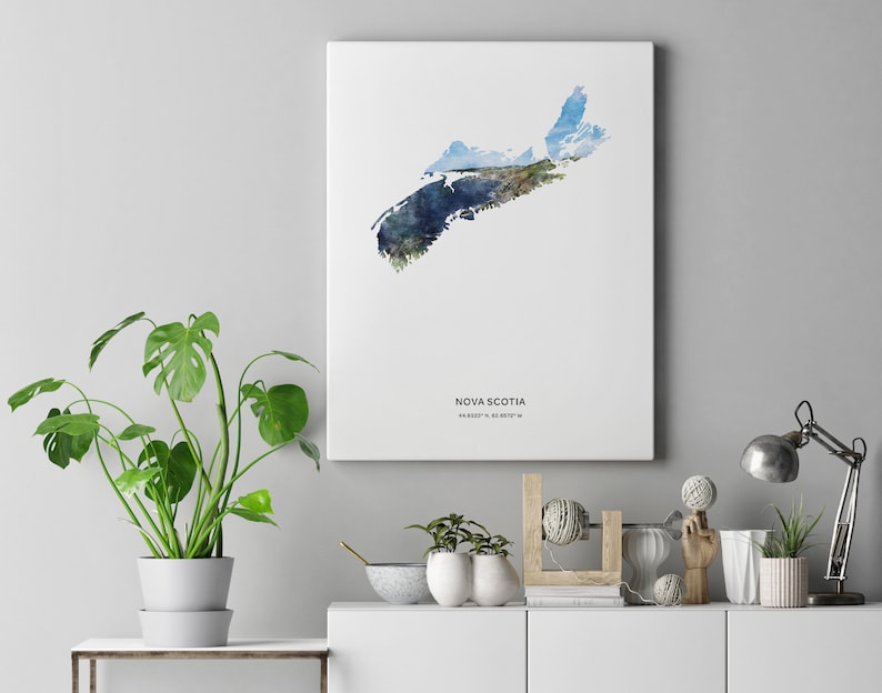 May include: A watercolor print of the outline of Nova Scotia, Canada, with a blue and green color scheme. The print is on a white background and includes the text "NOVA SCOTIA 44.6529&deg; N, 63.5877&deg; W".